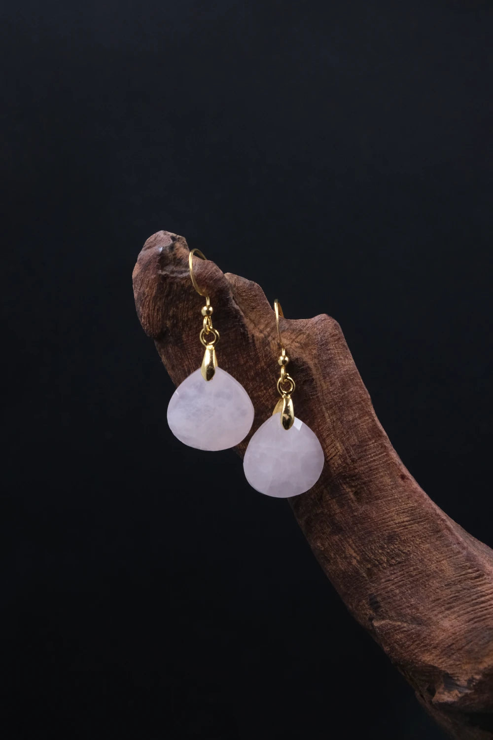 Pair of Tibetan Rose Quartz Earrings with gold hooks on a dark background, for Love, Social Connection & Emotional Healing