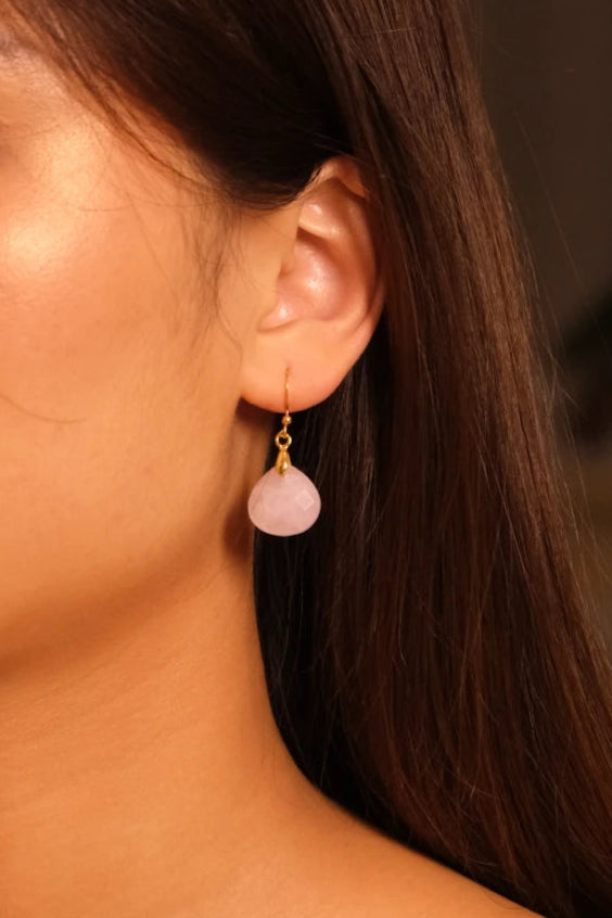 Close-up of an ear wearing Tibetan Feng Shui Drop Earrings – Rose Quartz for Love, Social Connection & Emotional Healing