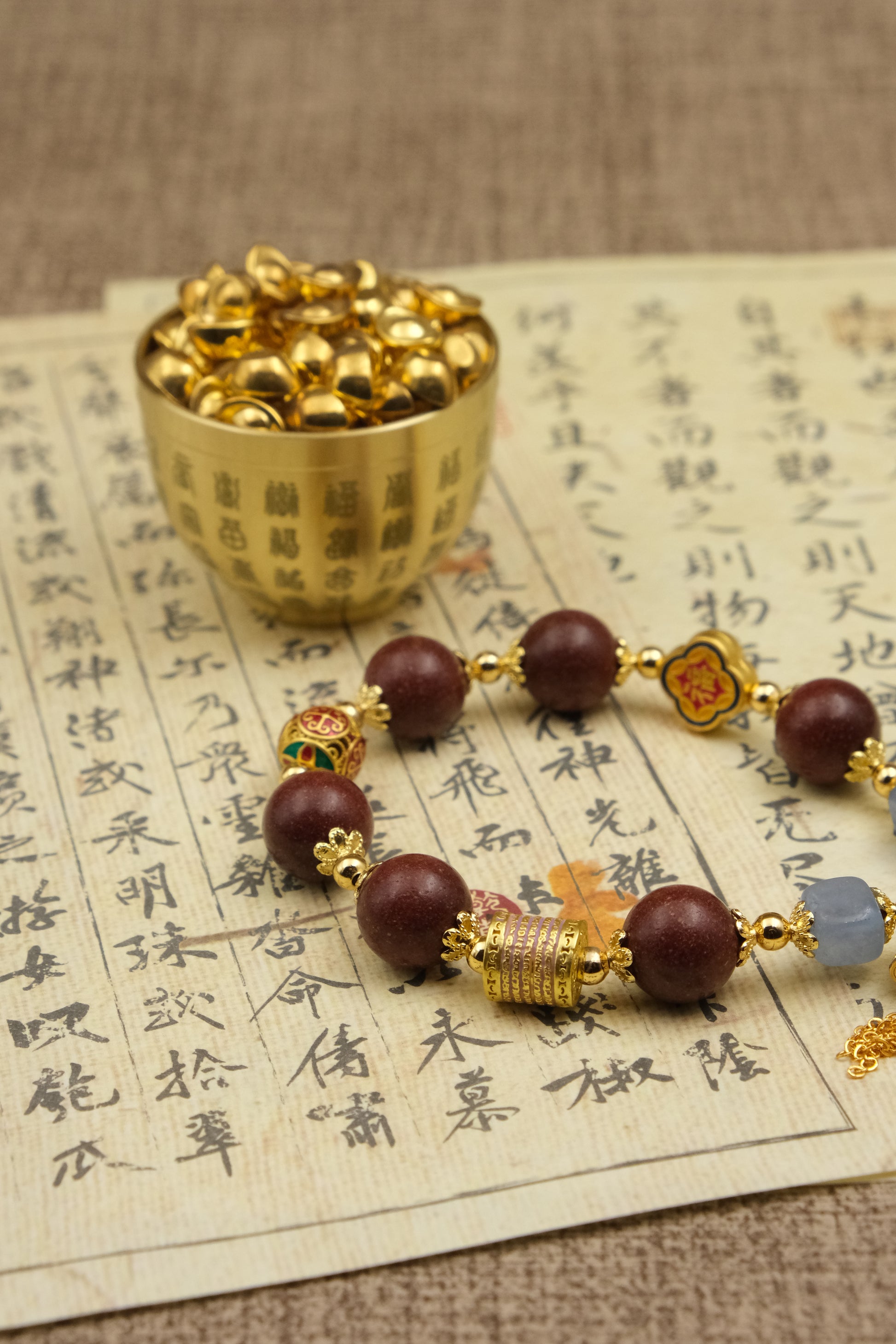 Gold cup with small round objects on a piece of paper with Chinese text,Tibetan Five Elements Aromatherapy Bracelet – Handcrafted Incense Beads with Ancient Tibetan Craft for Blessings, Energy Cleansing & Inner Balance