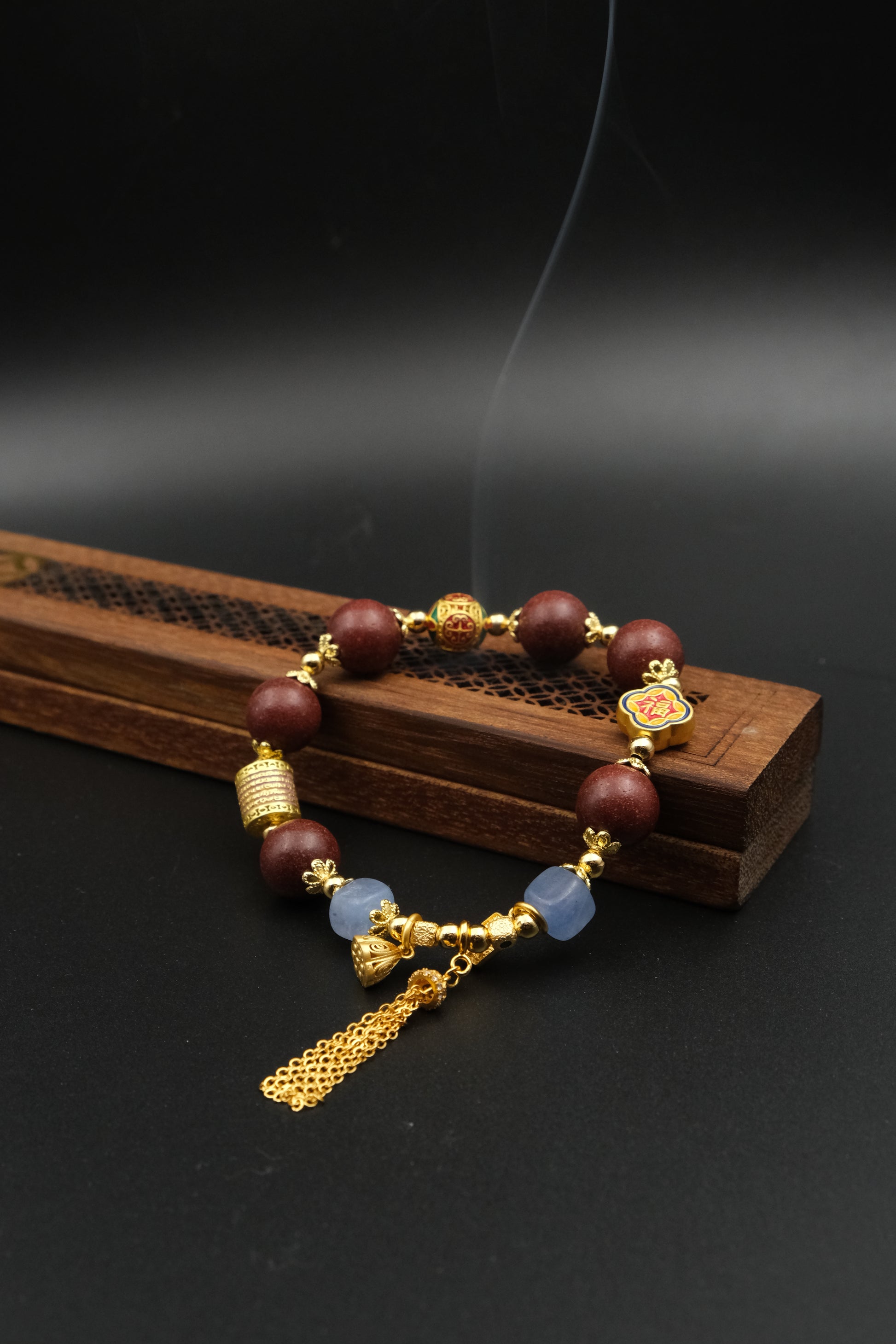 Tibetan Five Elements Aromatherapy Bracelet with beads and gold accents on a dark background,Cleansing Inner Balance