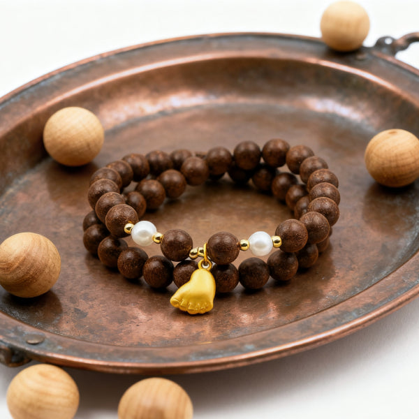 Brown beaded bracelet with a yellow charm on a copper tray