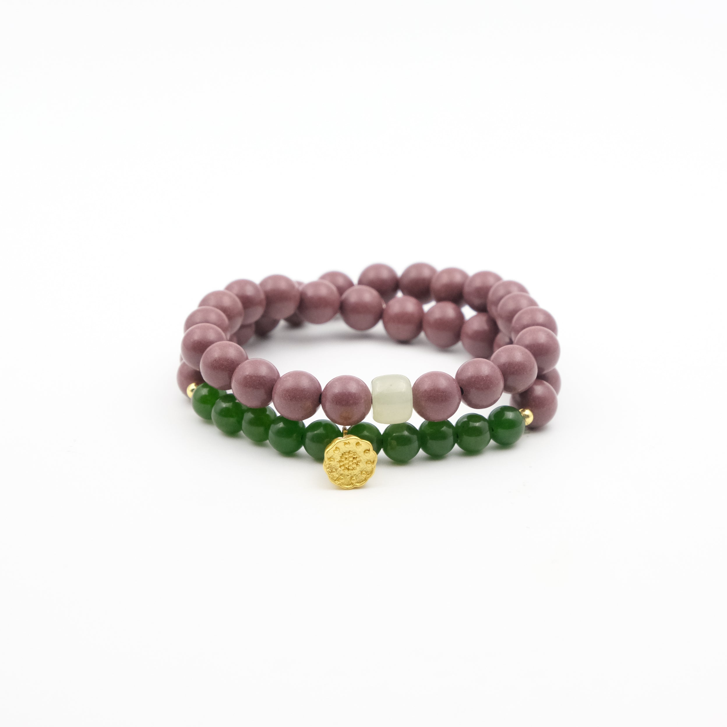 Tibetan Five Elements Aromatherapy bracelets with purple, green, and gold beads on a white background