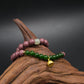 Two-cycle Aromatherapy beaded bracelets on a piece of wood with a dark background,Protection_Clarity_Wish_Fulfillment