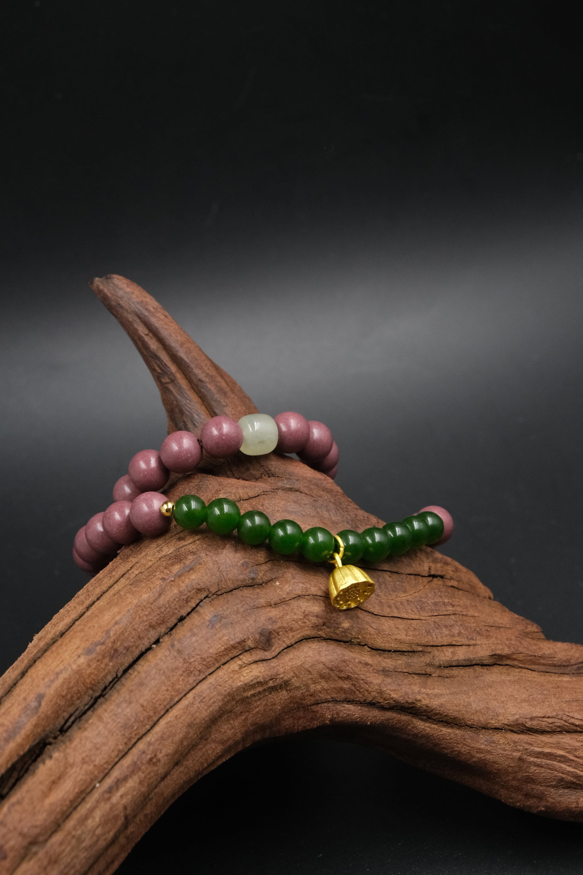 Two-cycle Aromatherapy beaded bracelets on a piece of wood with a dark background,Protection_Clarity_Wish_Fulfillment