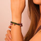 Woman wearing a bicolor Aromatherapy bracelet on a beige background