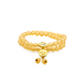 A Tibetan Five Elements Flow Bracelet composed of two layers of translucent yellow foil ash - glass beads. Adorned with a golden temple charm and a small decorative piece above it with blue inlays. This bracelet is believed to bring clarity, prosperity, and grounded wisdom. 