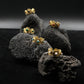 Gold earrings with gemstones on a dark textured surface. Tibetan Five Elements Ring – Tiger’s Eye for Success & Abundance
