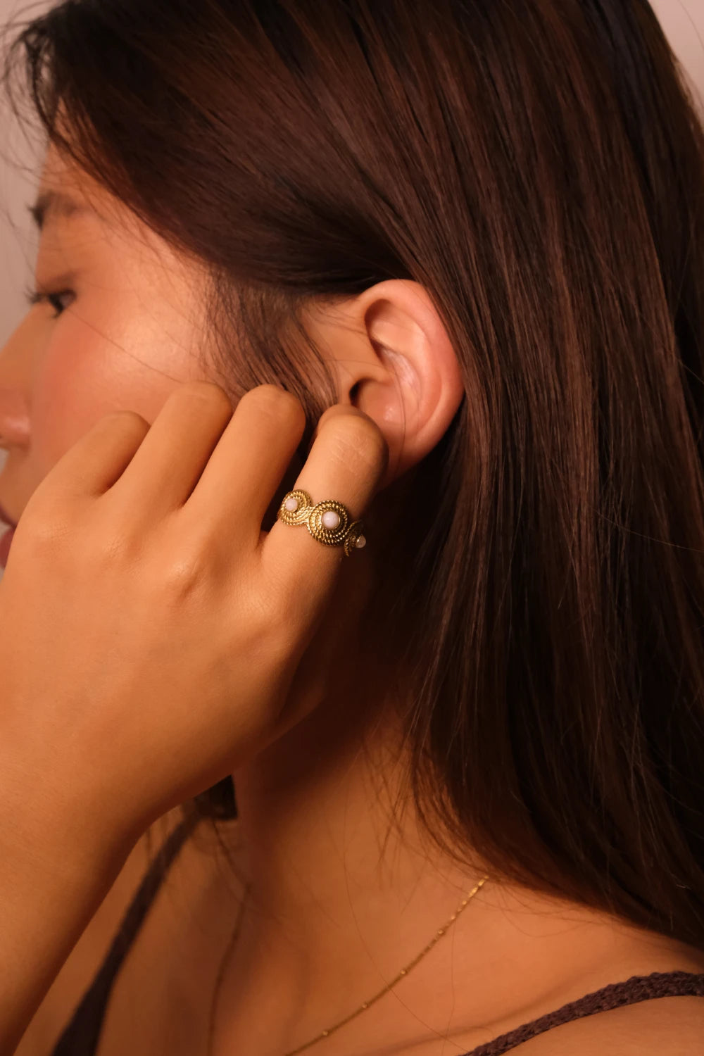 Close-up of a person wearting Tibetan Five Elements Ring with White Agate for Calm & Spiritual Balance on their finger.