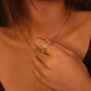 Close-up of a person wearing a Tibetan Five Elements Ring with White Agate for Calm & Spiritual Balance against a warm-toned background.