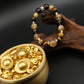 Tibetan Goldwish Crystal Bracelet with gold and black beads on a dark background