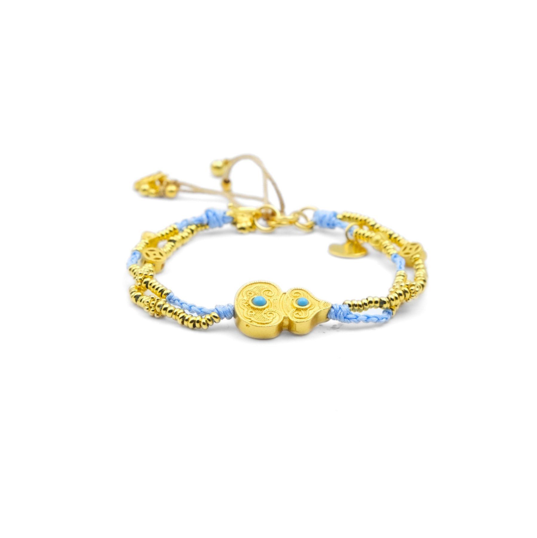 A Tibetan Harmony Double Bracelet featuring a golden gourd charm adorned with turquoise accents, strung with blue cord and golden beads, symbolizing luck and protection.