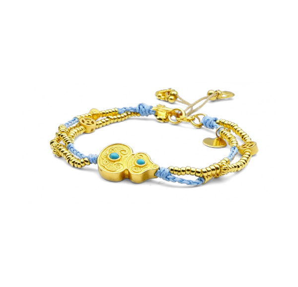Gold bracelet with blue beads on a white background