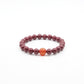 Tibetan Heart Sutra Cinnabar Beaded bracelet with a single orange bead on a white background