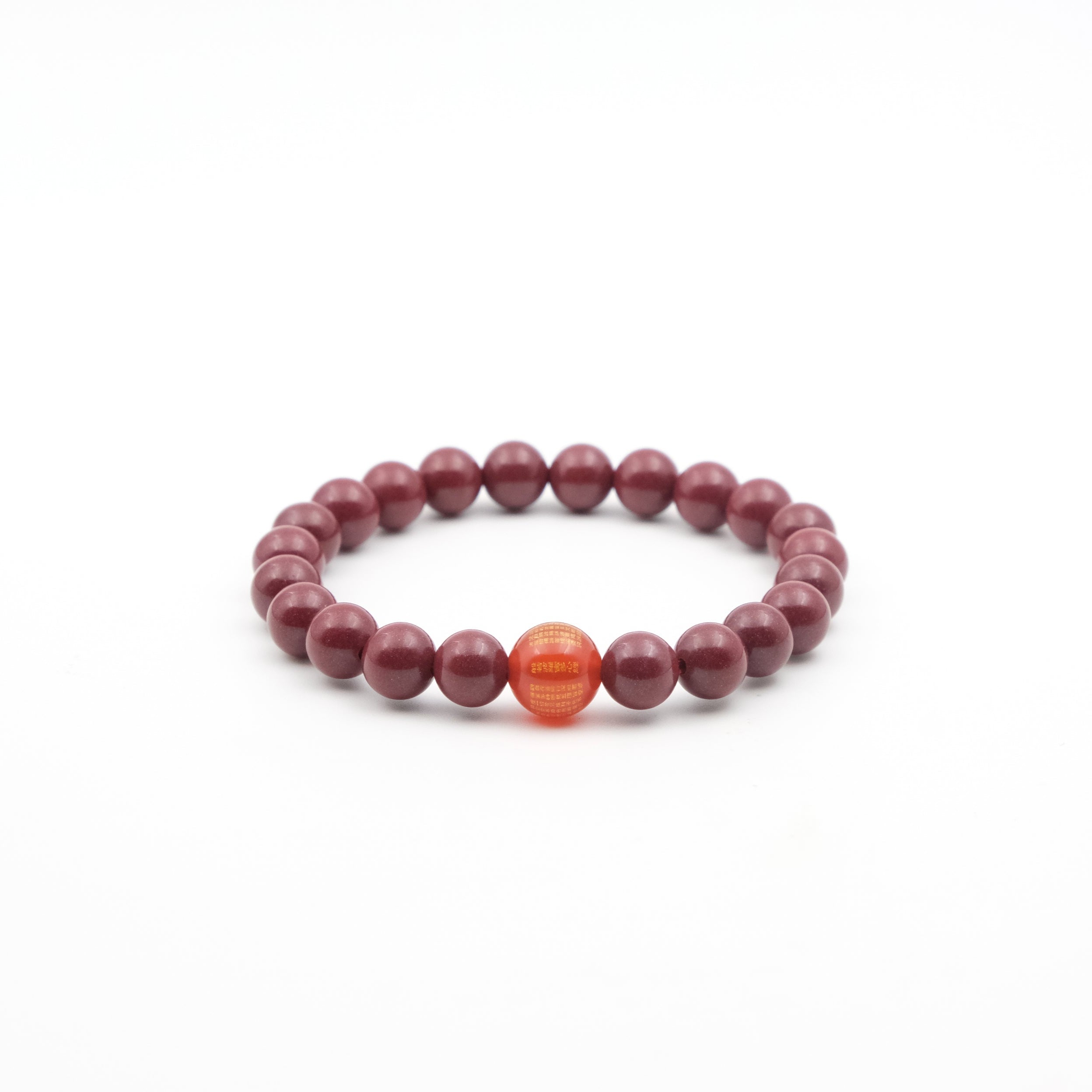 Tibetan Heart Sutra Cinnabar Beaded bracelet with a single orange bead on a white background