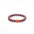 Tibetan Heart Sutra Cinnabar Beaded bracelet with a single orange bead on a white background