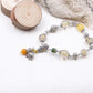Tibetan Mantra Crystal Energy Beaded bracelet with natural elements on a textured surface