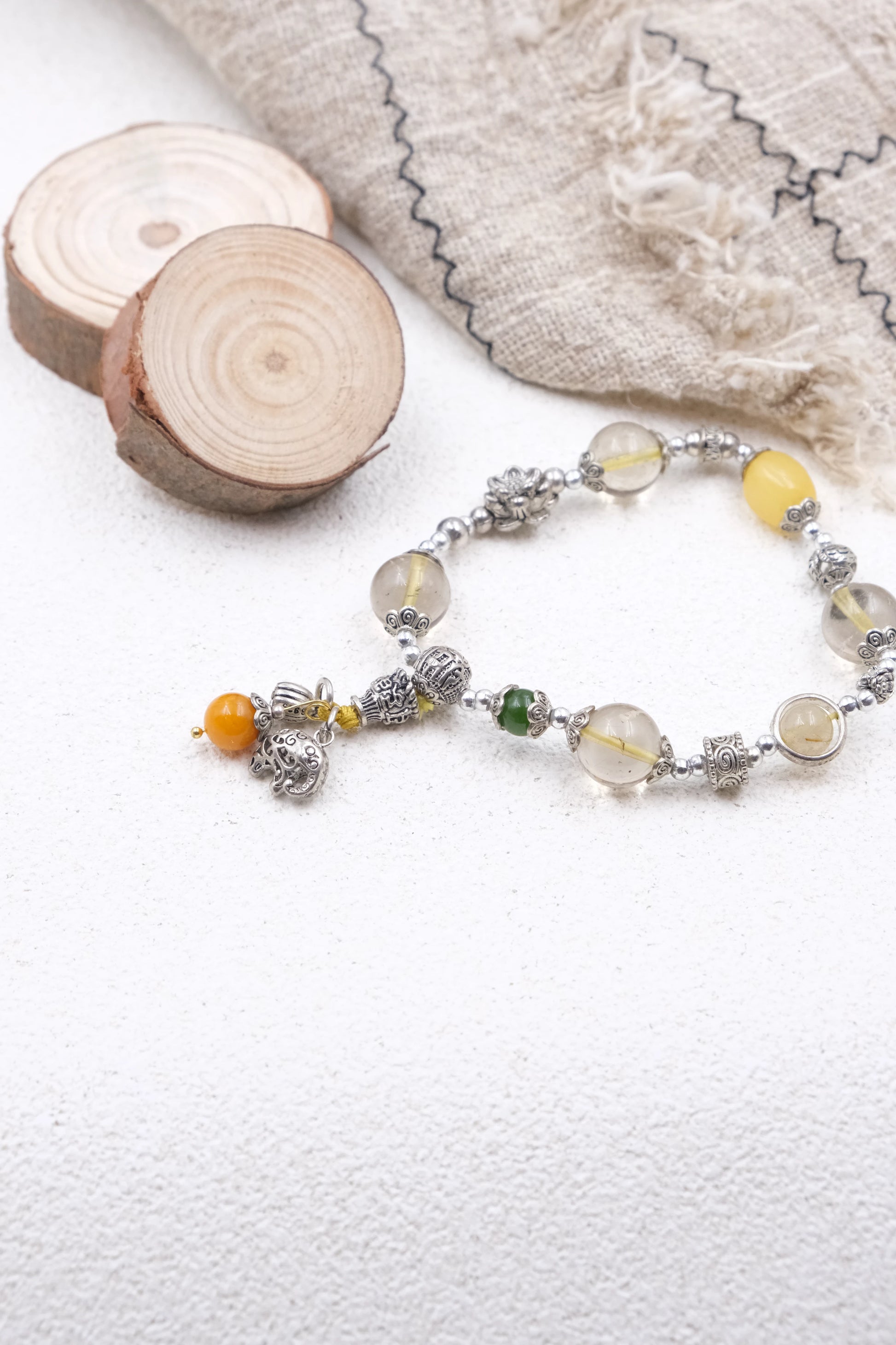 Tibetan Mantra Crystal Energy Beaded bracelet with natural elements on a textured surface