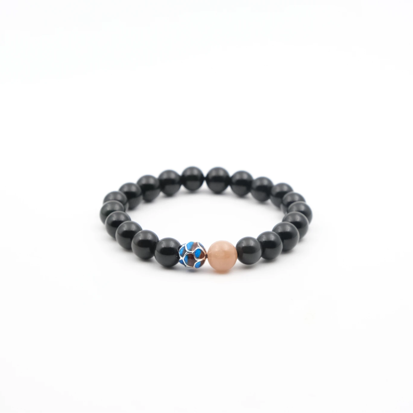 Black beaded Protection, Vitality & Inner Peace bracelet with a blue and pink accent bead on a white background