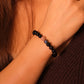 Close-up of a person's wrist wearing a Tibetan Meditation black beaded bracelet.