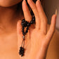 Hand holding Grounding & Protection – Tibetan Meditation Spinner with a blurred background