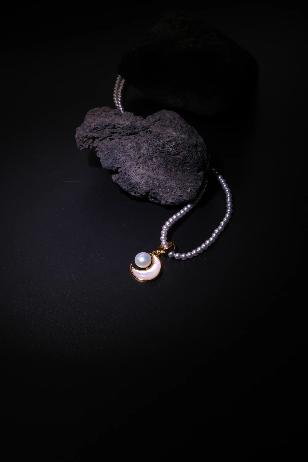 Handcrafted Tibetan Moonlight Pendant Necklace with glowing mother-of-pearl and pearls, associated with inner peace, feminine energy, and healing harmony.