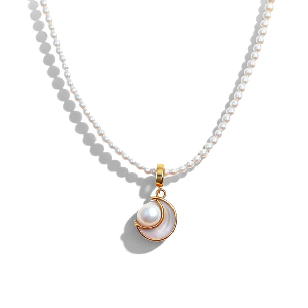 Pearl necklace with a gold pendant on a white background