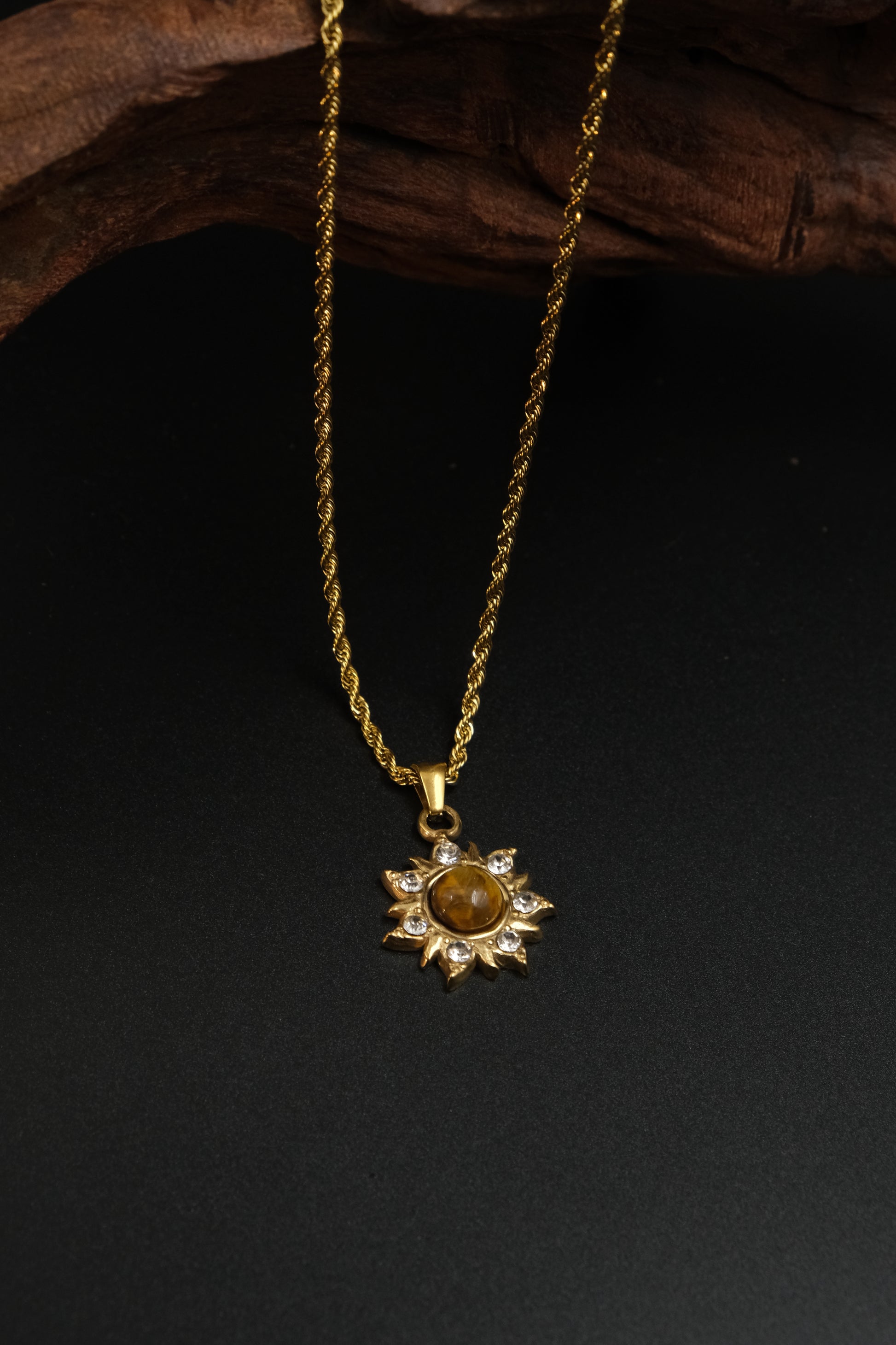 Success & Abundance – Tibetan Sun Pendant with a sun-shaped pendant on a dark background