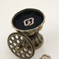 Feng Shui Lotus Pedestal Incense Burner in bronze finish, shown with its lid open to reveal incense chips inside, displayed together with cloud-shaped incense coils.
