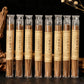 Row of Himalayan Handcrafted incense sticks in clear tubes with labels on a dark background