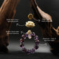 Bodhi Root for Mindfulness & Protection, Amethyst beaded necklace with gold accents and a white flower pendant on a dark background