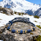 Blue beaded bracelet on a rock with a mountain in the background