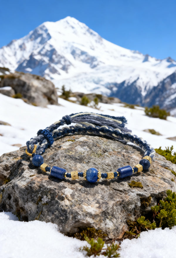 Blue beaded bracelet on a rock with a mountain in the background