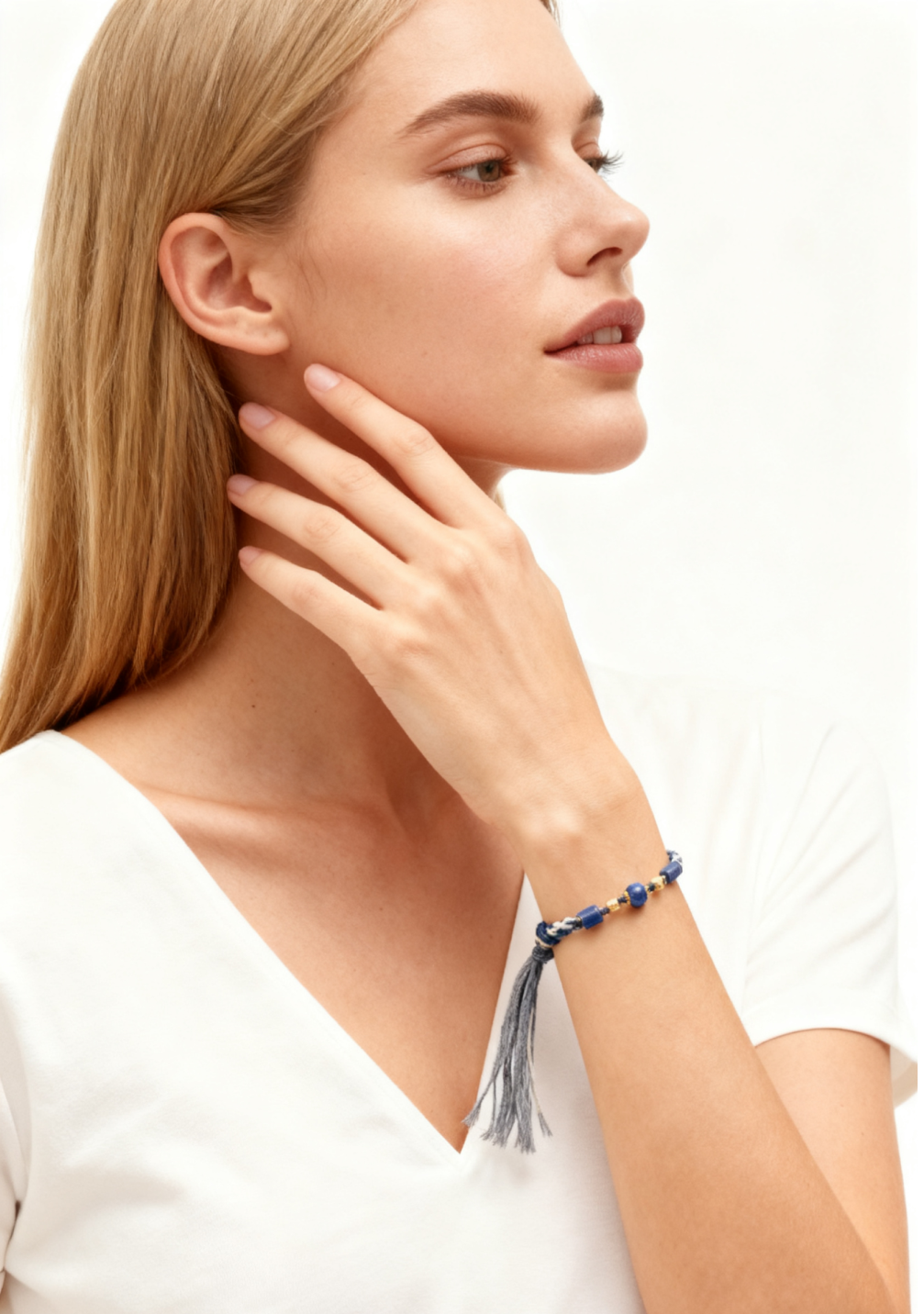 Woman wearing a blue beaded bracelet on a white background