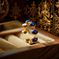 Gold and Lapis Lazuli Open Ring with religious statues and prayer flags in the background