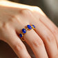 Tibetan lapis lazuli open ring on a person's finger against a blurred background